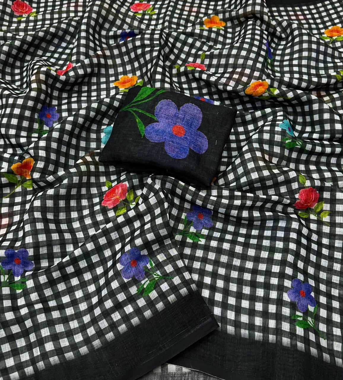 Black and white checkered fabric with embroidered flowers on a black background