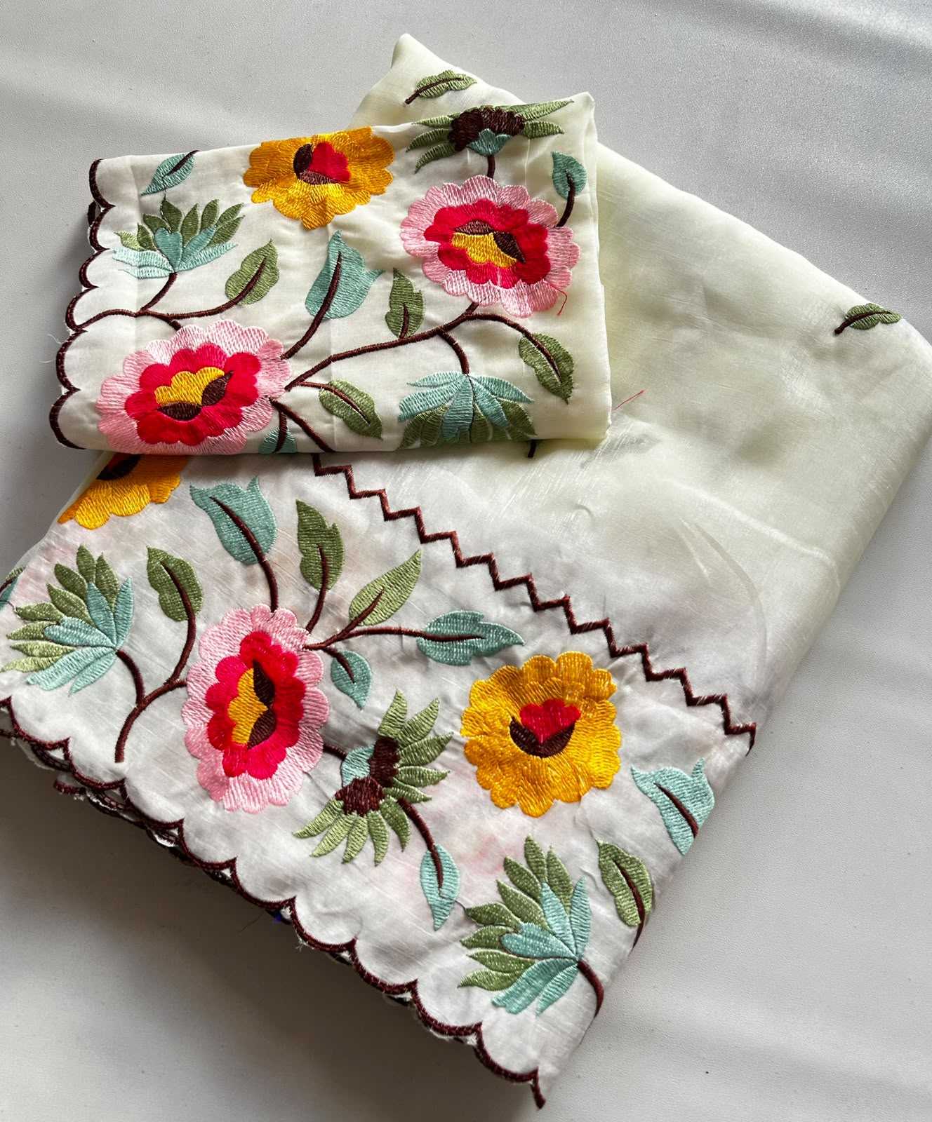 Embroidered fabric with floral patterns on a white background