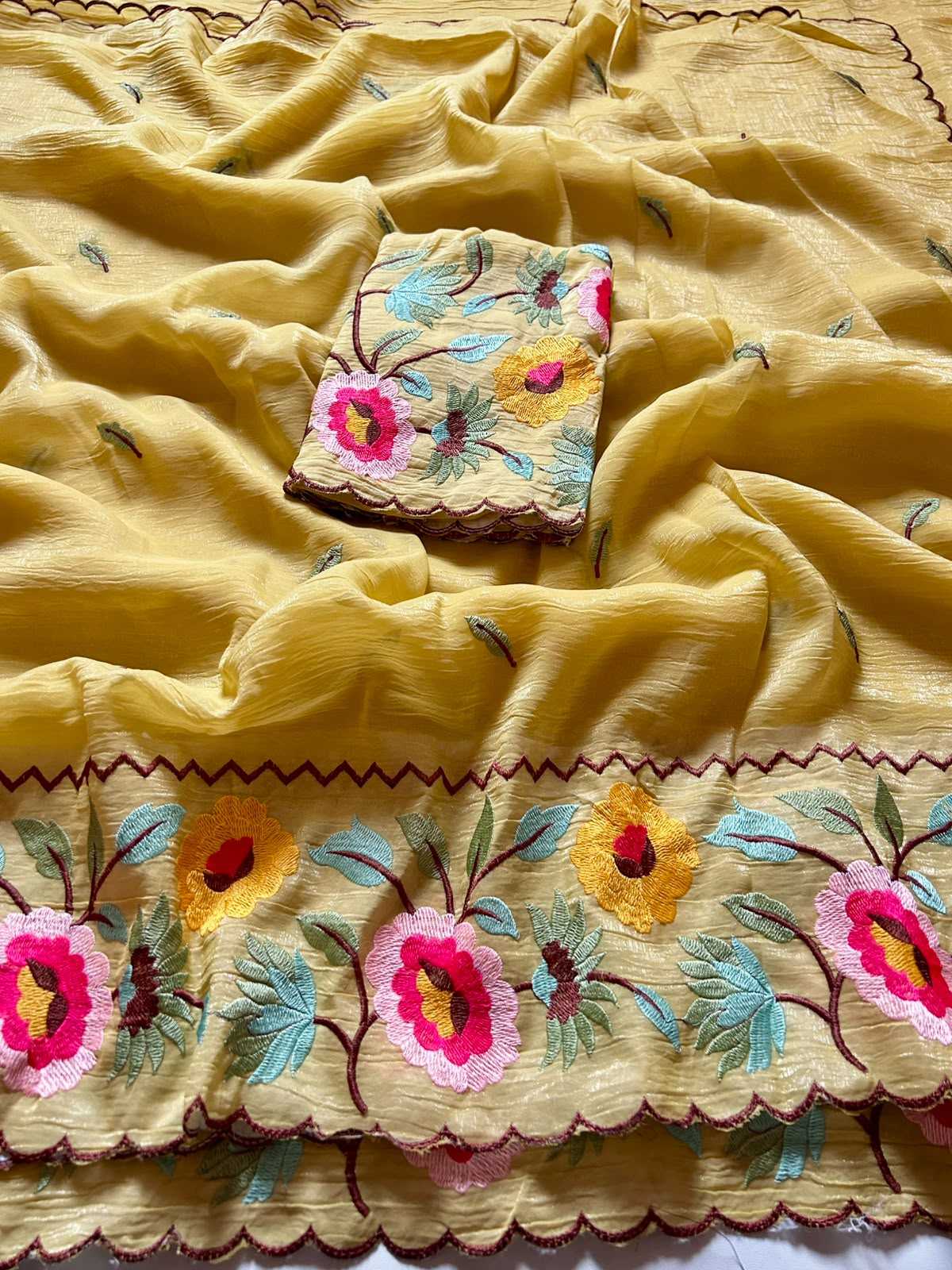 Embroidered fabric with floral patterns on a yellow background
