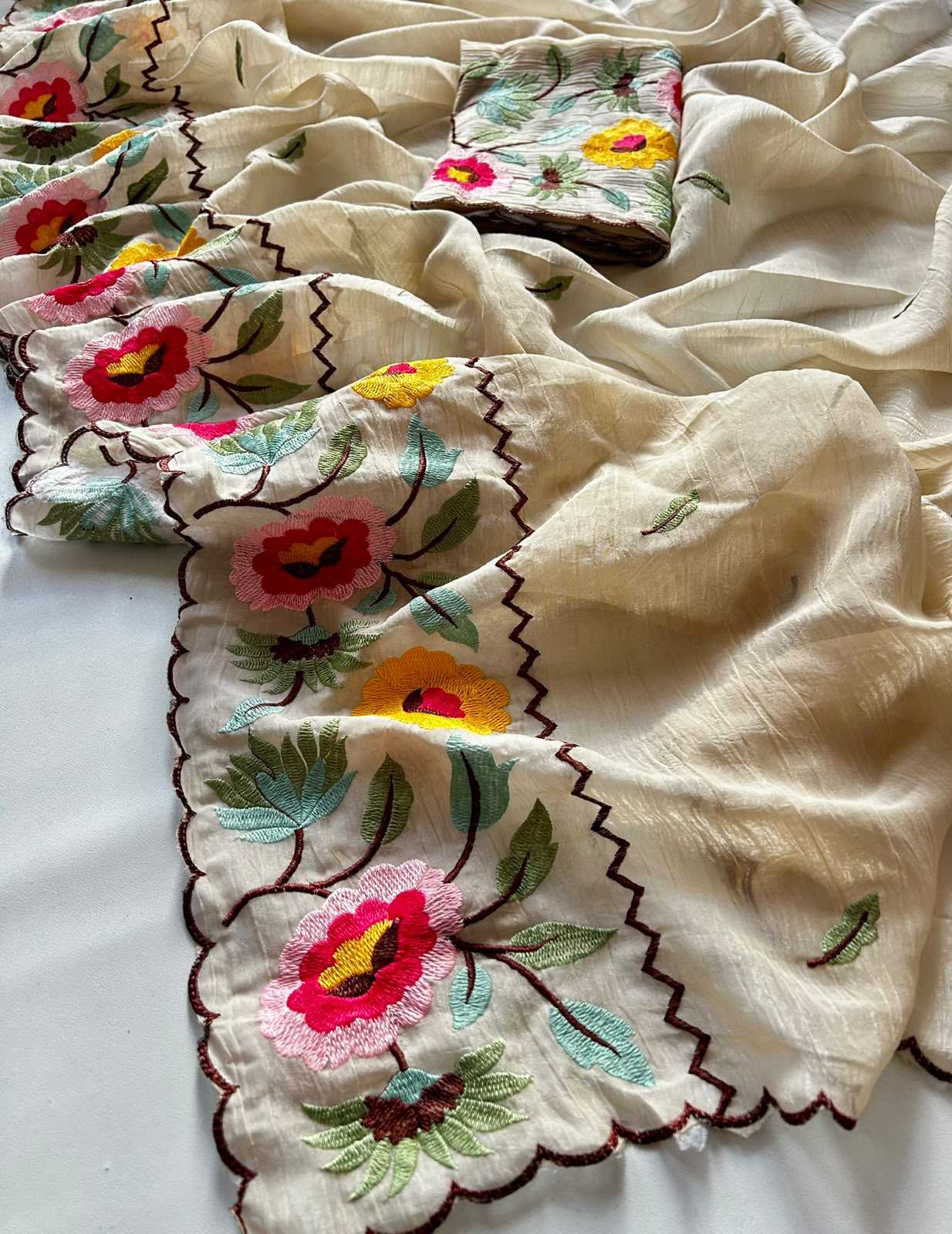 Embroidered fabric with floral patterns on a white background