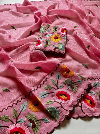 Pink fabric with floral embroidery on a white background