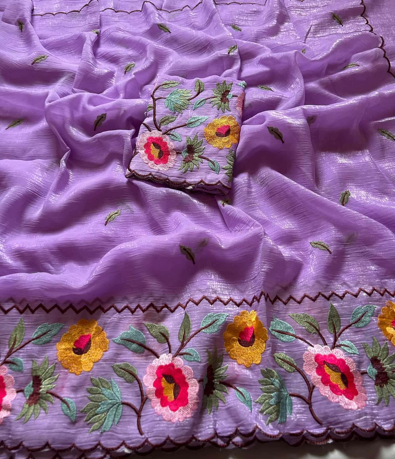 Embroidered fabric with floral patterns on a purple background