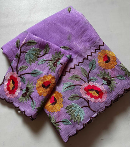 Purple fabric with floral embroidery on a light gray background