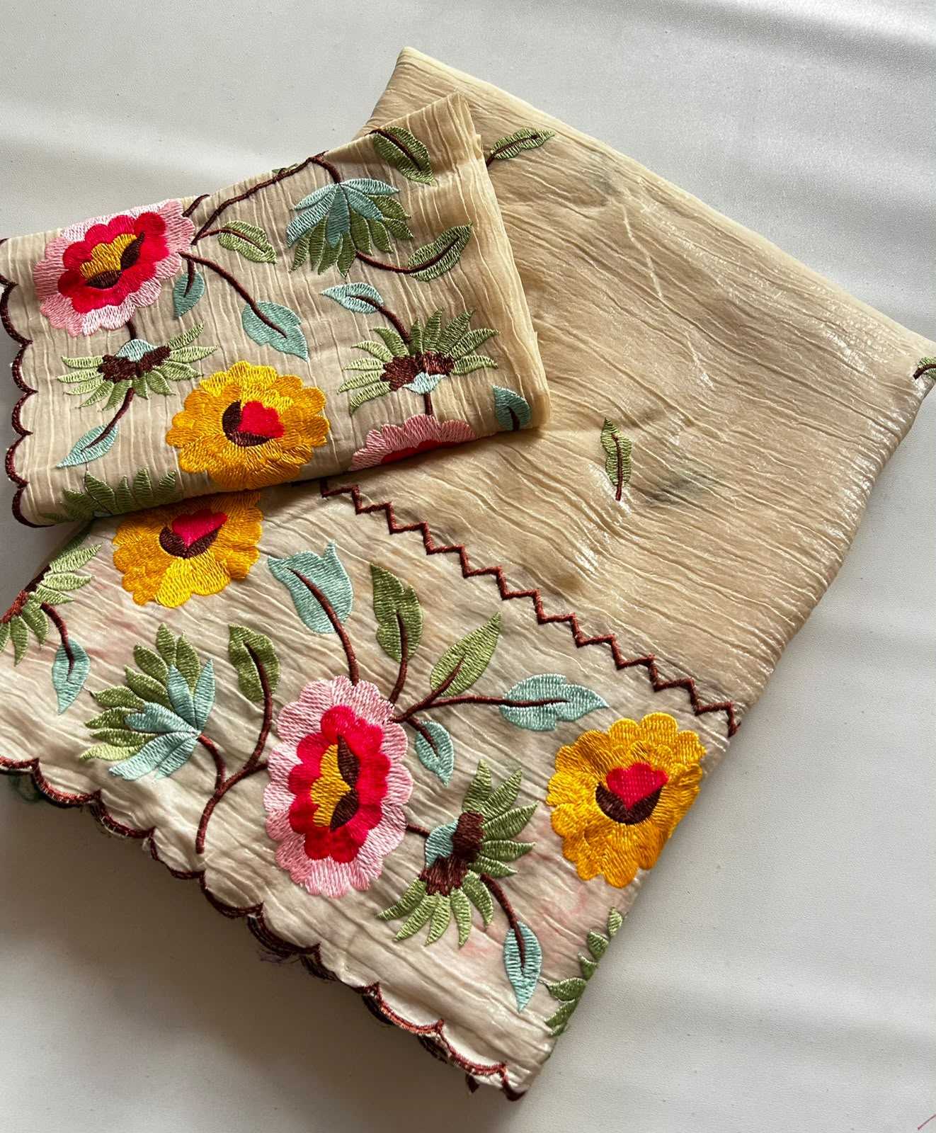 Embroidered fabric with floral patterns on a light background