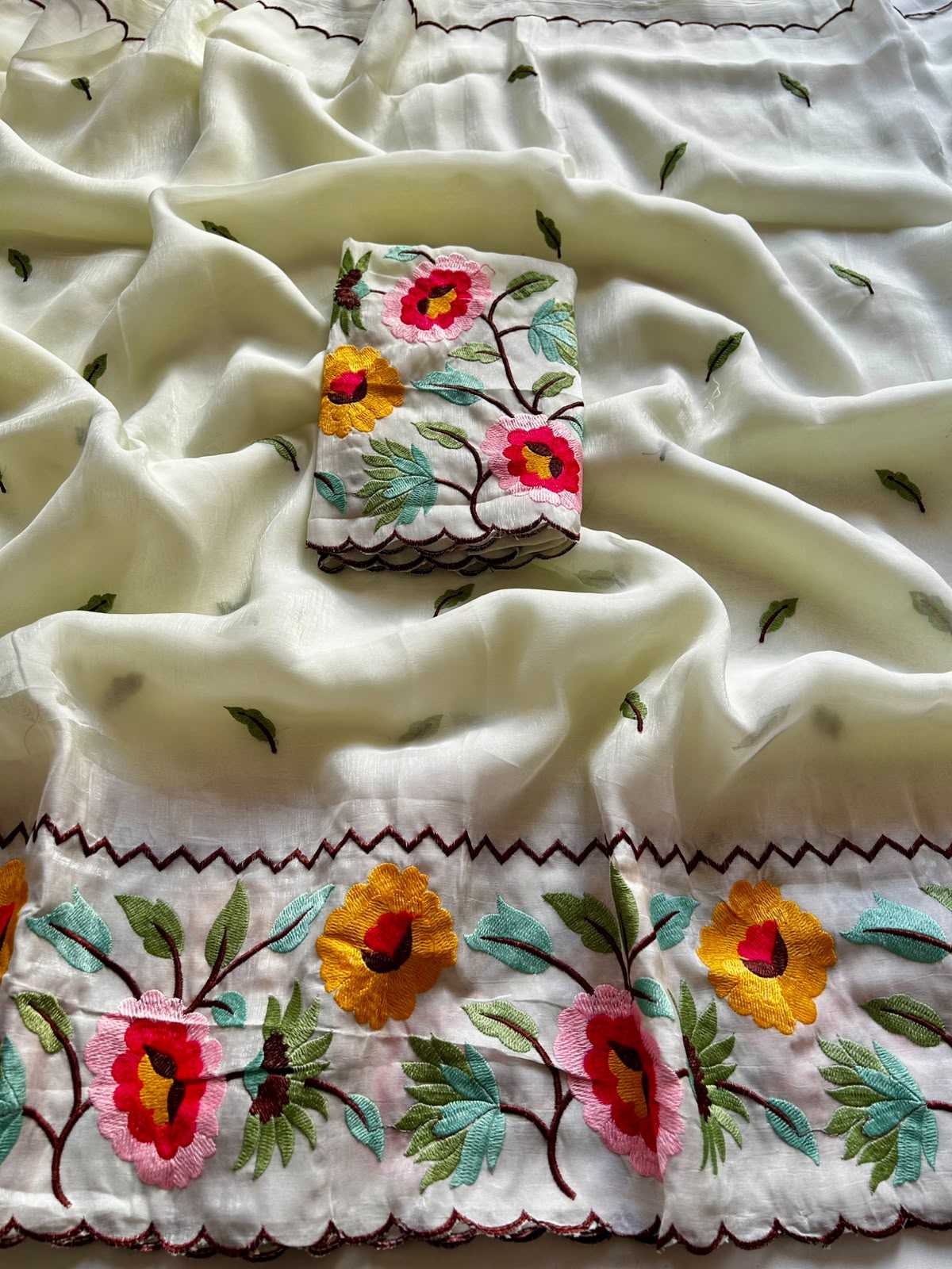 Embroidered fabric with floral patterns on a white background