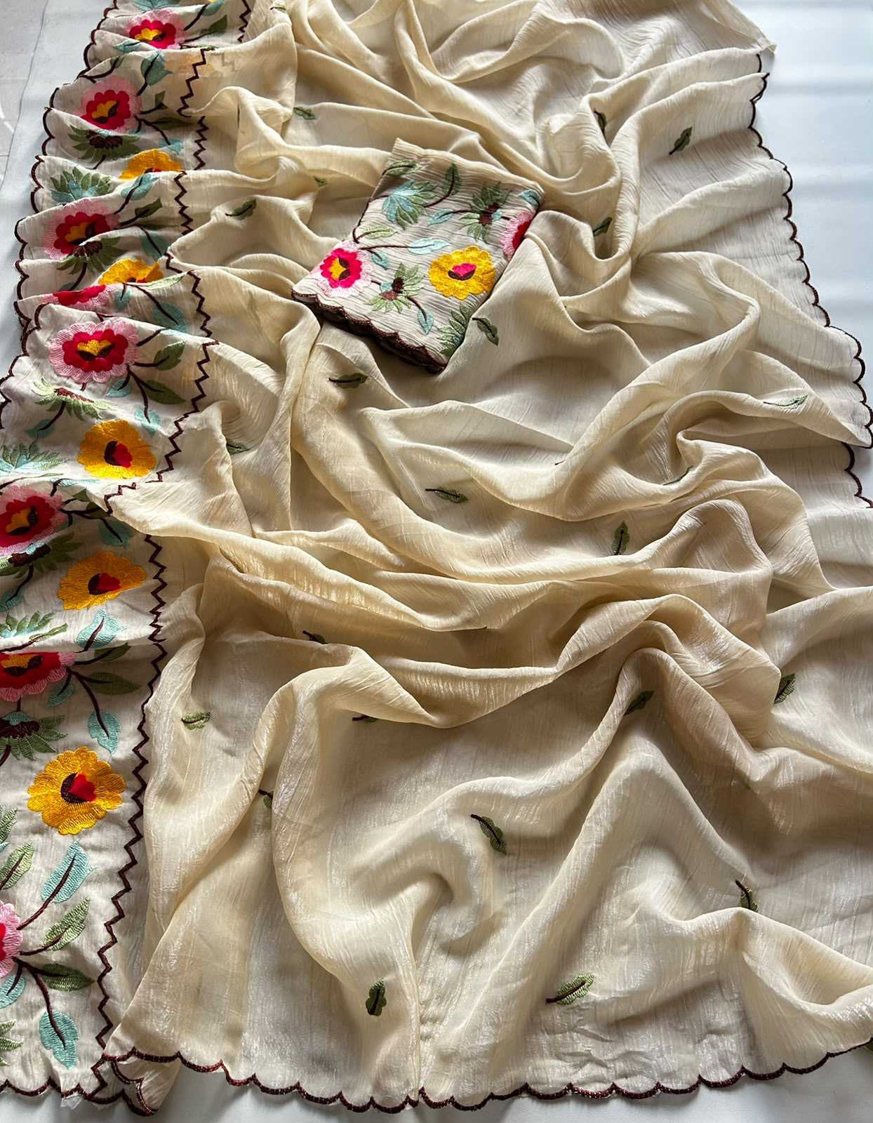 White fabric with floral embroidery on a white background