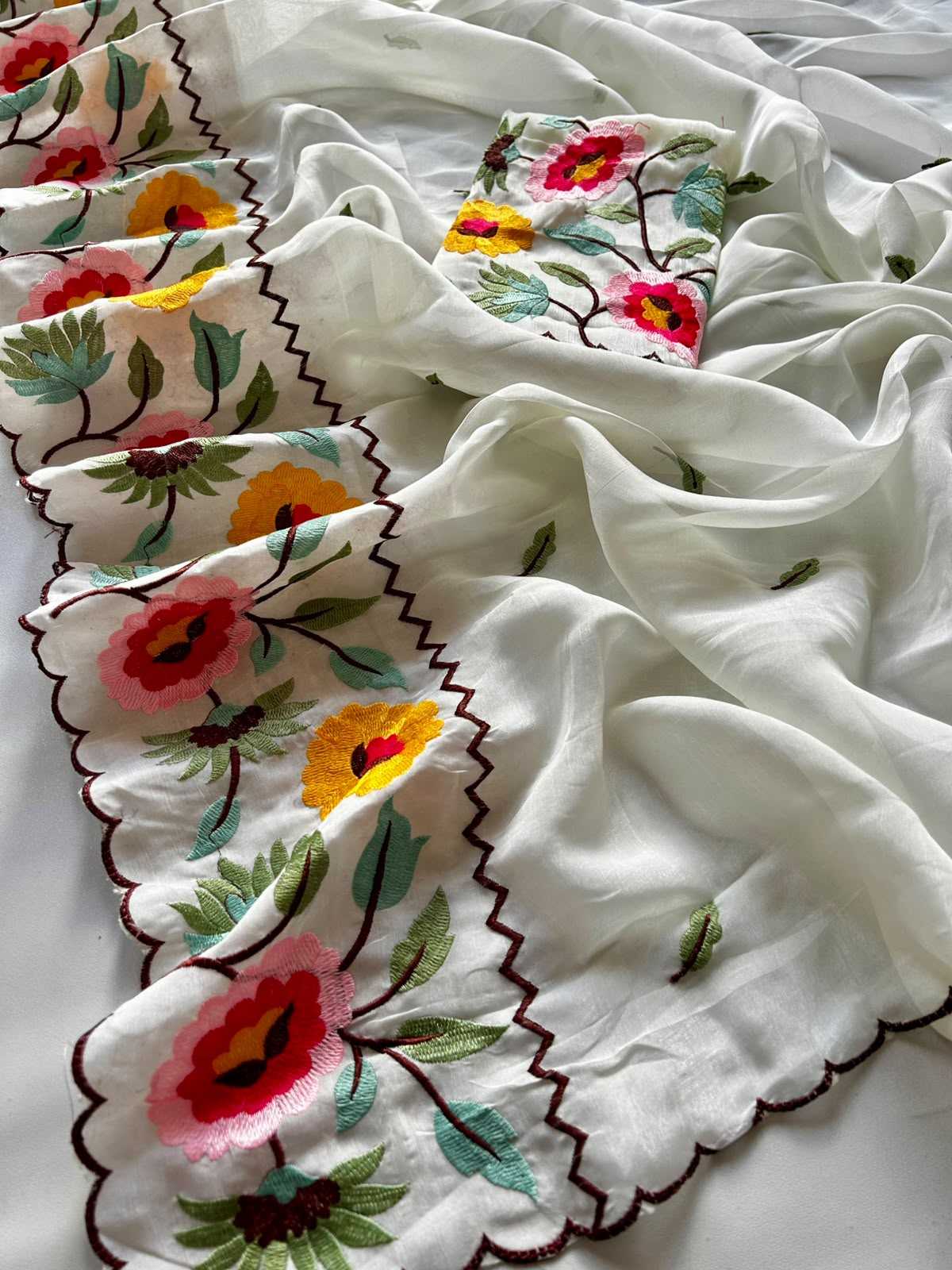 White fabric with colorful floral embroidery