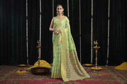 Woman wearing a light green saree with a black background