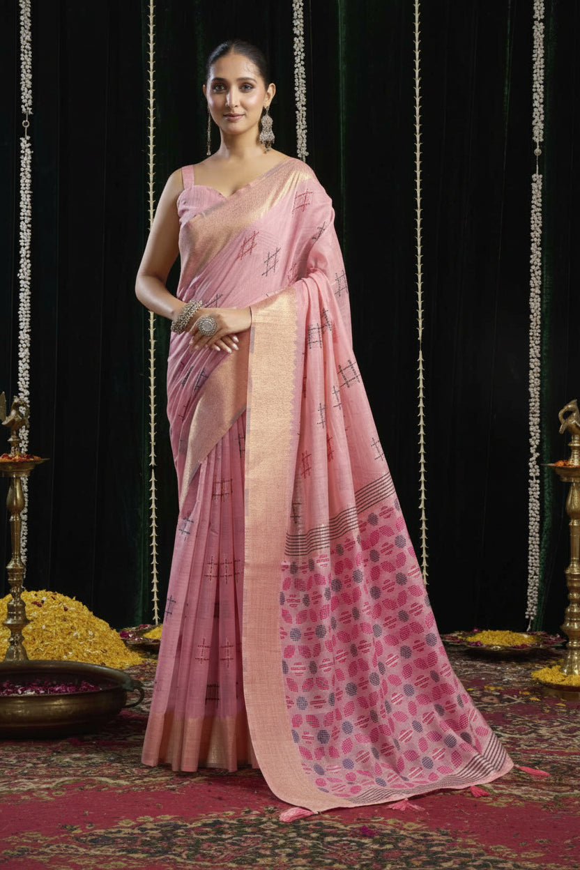 Woman wearing a pink saree with a traditional setting