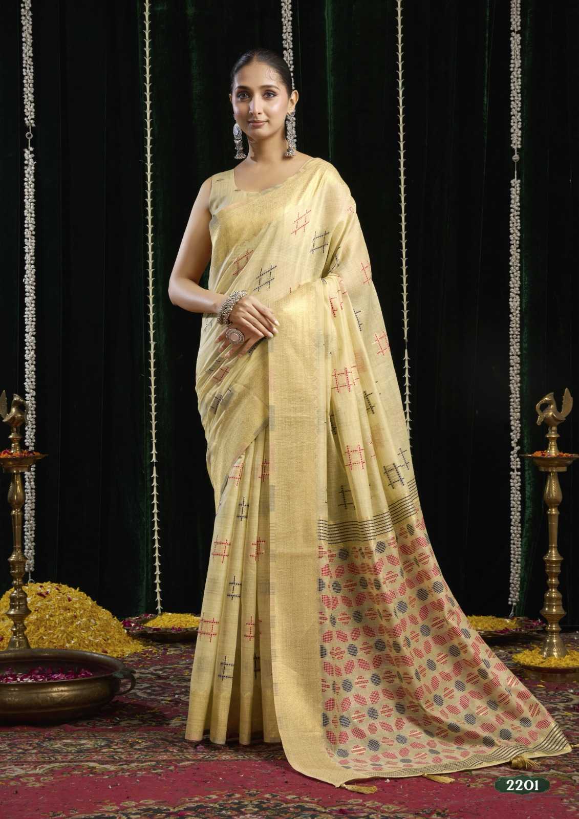 Woman wearing a traditional saree with a patterned design against a dark background