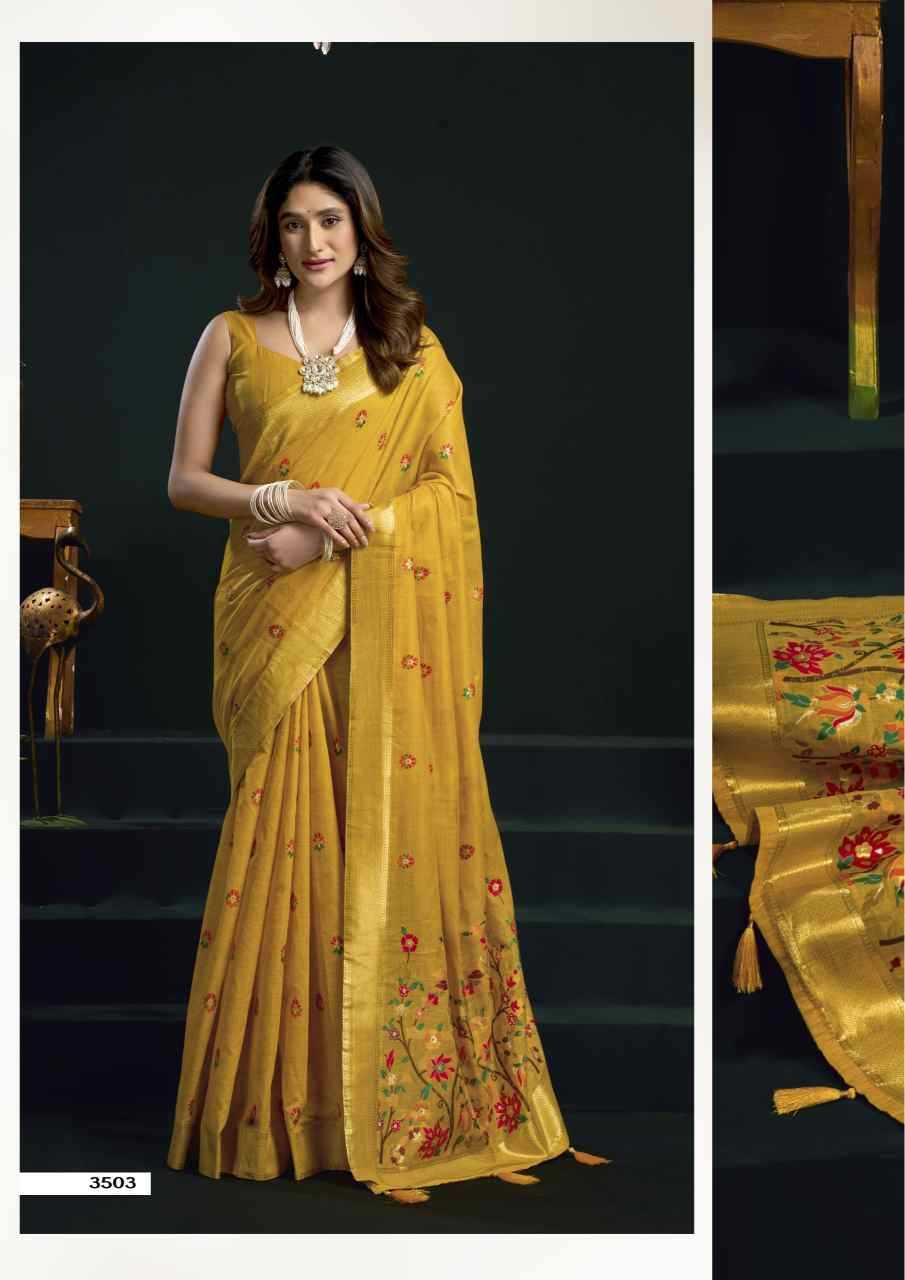 Woman wearing a yellow saree with floral patterns on a dark background