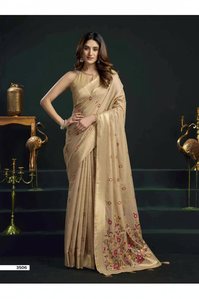 Woman wearing a beige saree with floral patterns in a dark setting with 'Gobuni' branding.