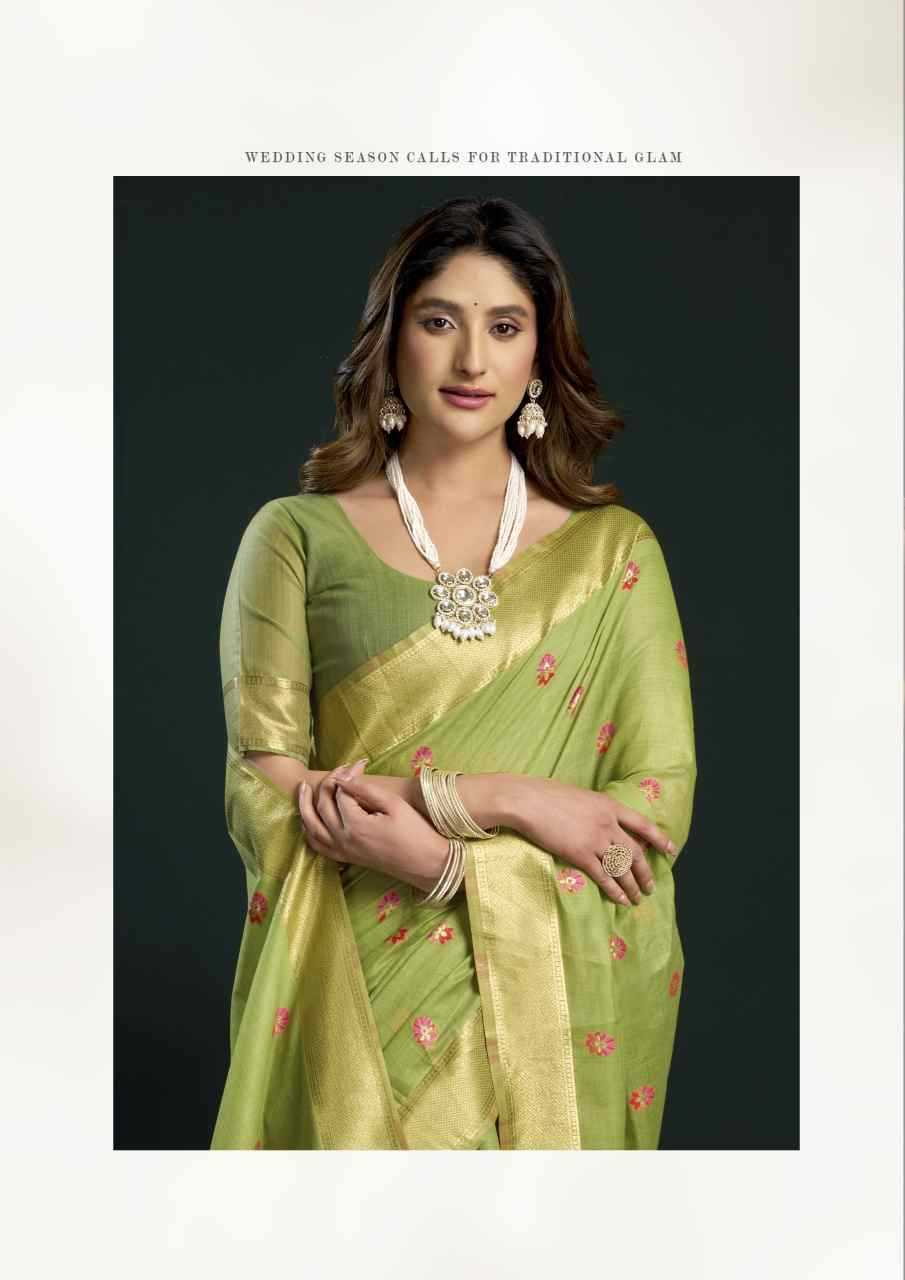 Woman wearing a green saree with a dark background