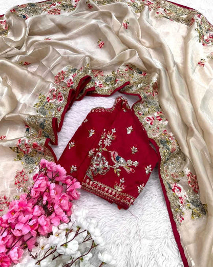 Red embroidered blouse with floral patterns on a beige fabric background