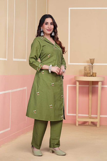 Woman wearing a green traditional outfit with a beige background