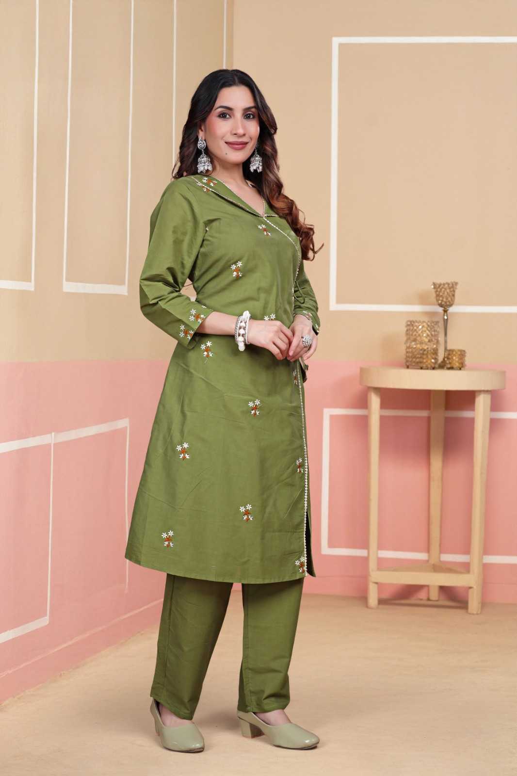 Woman wearing a green traditional outfit with a beige background