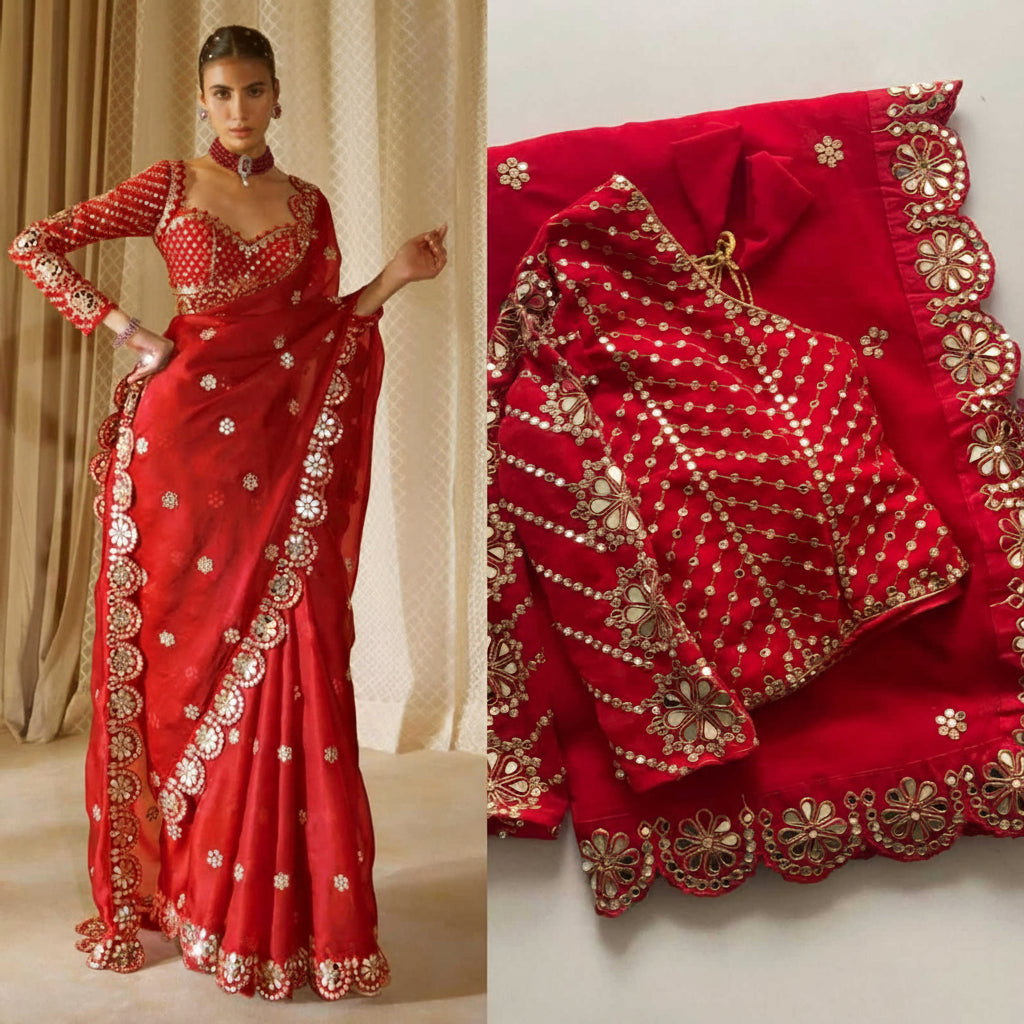 A red embroidered Indian ethnic outfit shown on a model and laid flat. The set includes a long red skirt or drape with gold and silver floral embroidery and mirror work, a matching red blouse with long sleeves and heavy embellishment, and a coordinating red dupatta with scalloped embroidered edges.