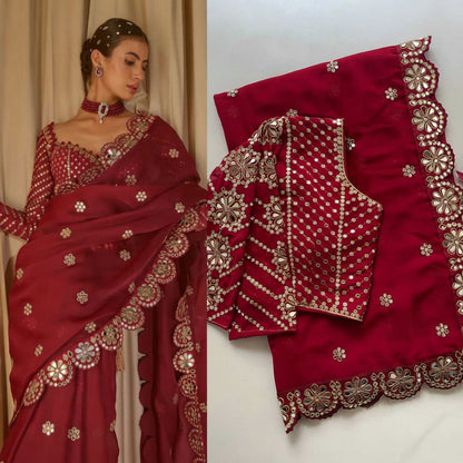 Red saree with gold embroidery displayed on a white background