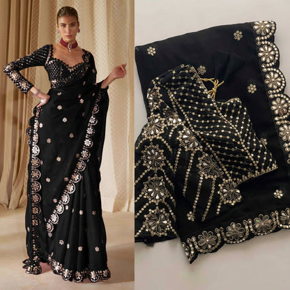 Black saree with gold embroidery worn by a model, close-up of saree details.