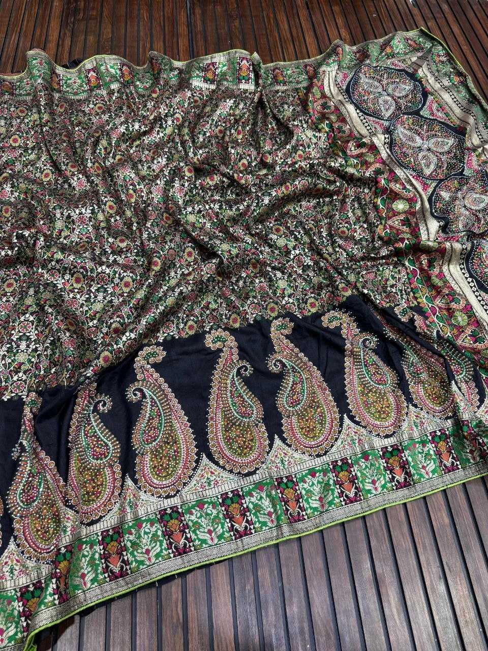 Traditional embroidered fabric with intricate patterns on a wooden surface