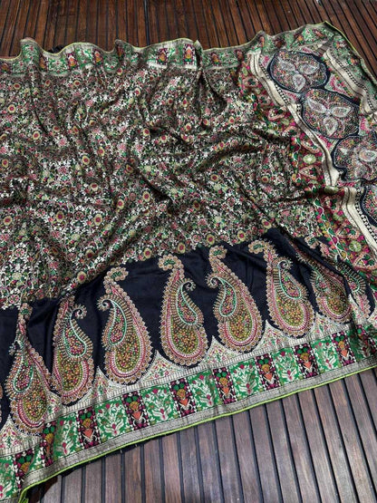 Traditional embroidered fabric with intricate patterns on a wooden surface