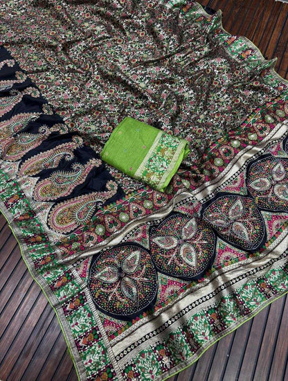 Colorful embroidered fabric with a green box on a wooden surface