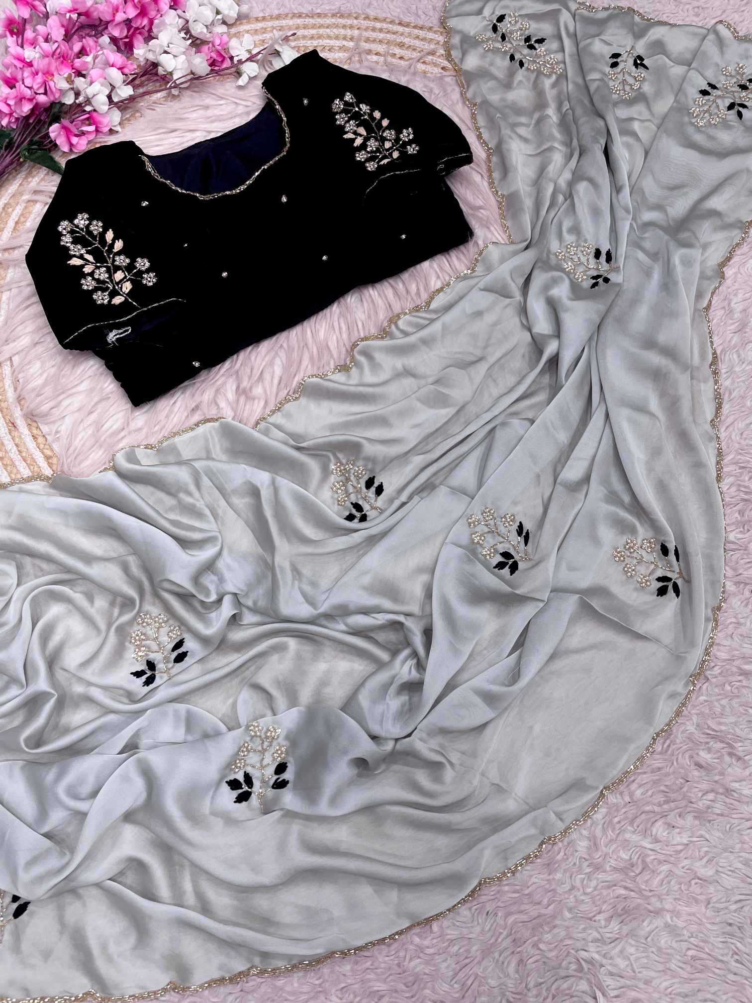 Gray saree with black blouse on a pink floral background