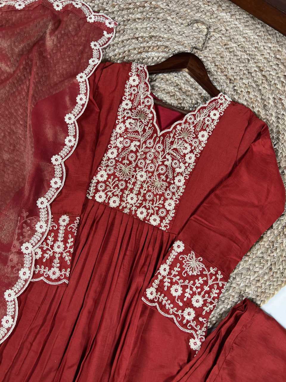 Red embroidered dress on a textured surface
