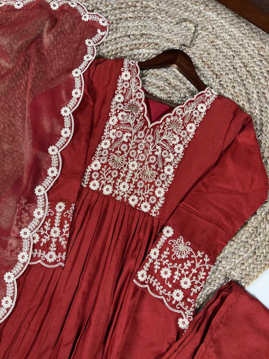 Red embroidered dress on a textured surface