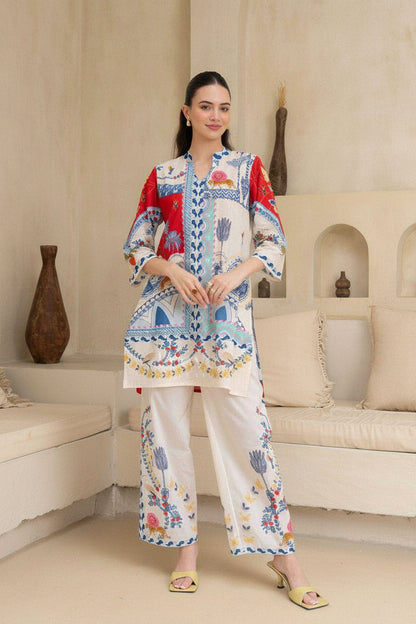 Woman wearing a colorful embroidered outfit in a living room setting