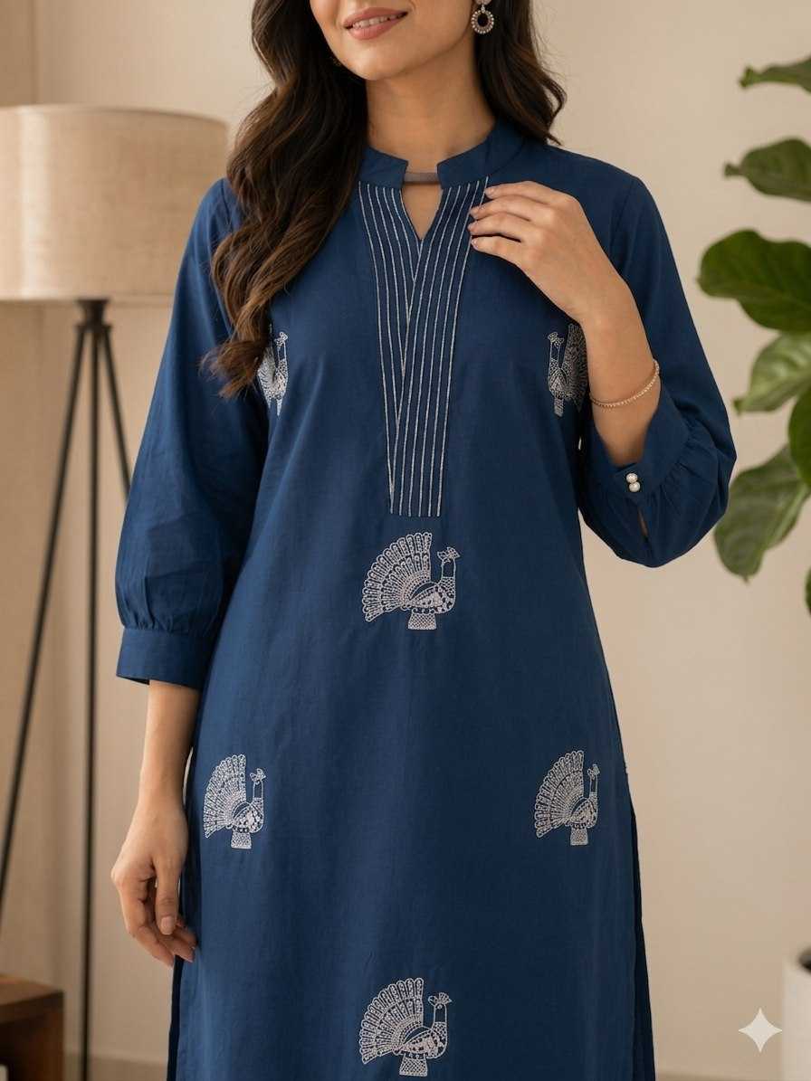 Woman wearing a blue dress with white patterns in a room setting.