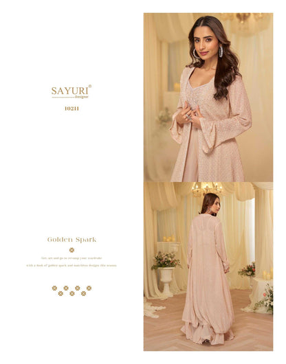 Woman in a light pink dress with 'Sayuri' branding in an elegant room.