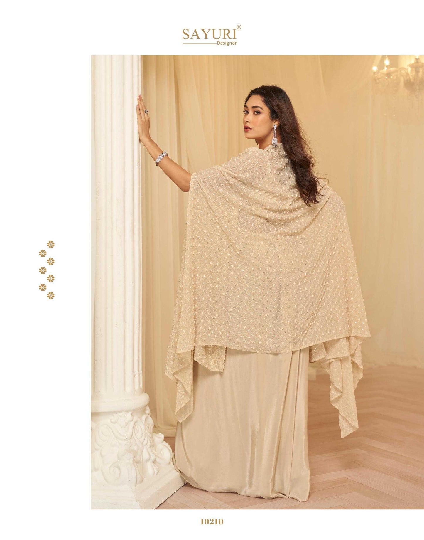 Woman wearing a beige saree with a matching shawl in a elegant indoor setting.