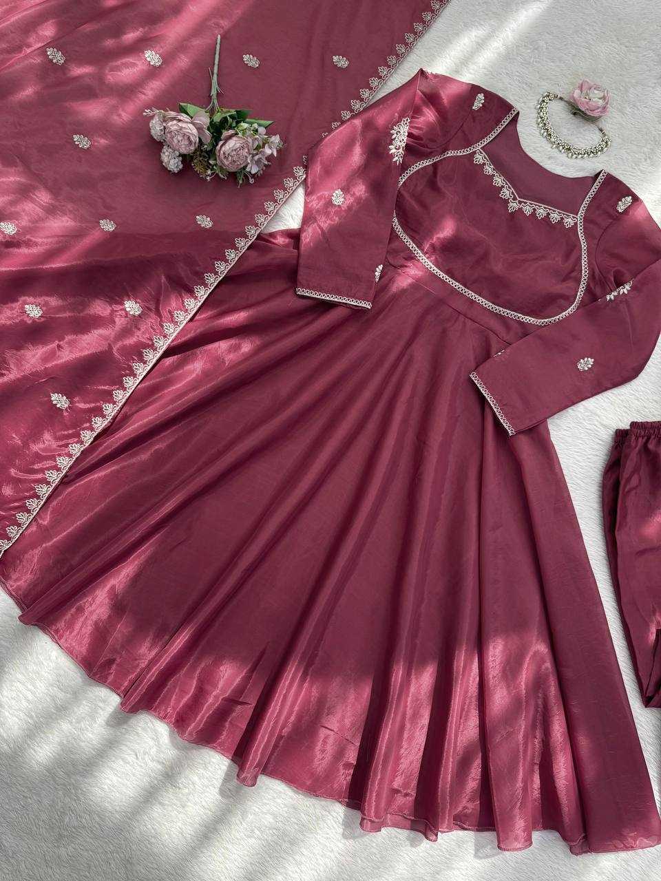 Maroon traditional outfit with matching saree and blouse on a light background